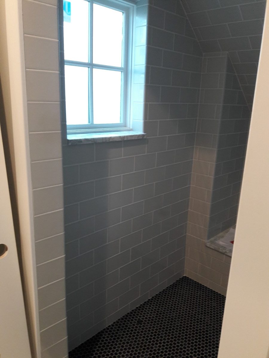 Marble sill used as a finished stone edge around a shower window, one clean way of edging for tiling