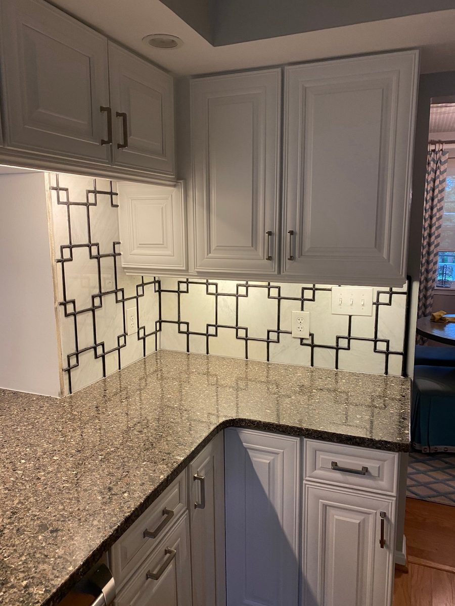 Outside corner of a marble backsplash where two tiled walls meet in a clean finished edge