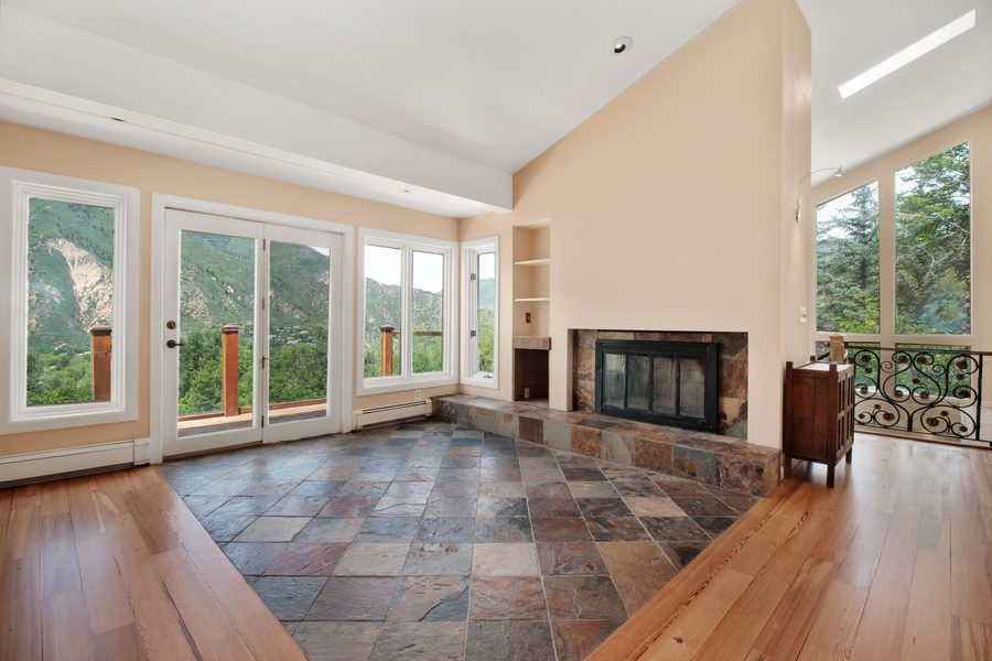 Slate stone tile hearth and surround framing a fireplace, a warm natural-stone idea for tiling a fireplace