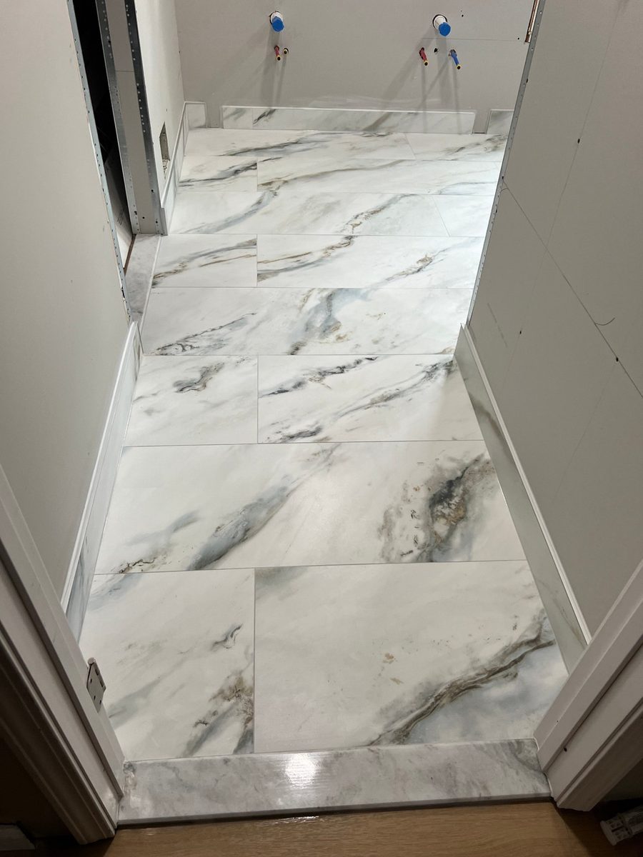 Finished marble-look tile bathroom floor, a natural fit for electric heat underneath
