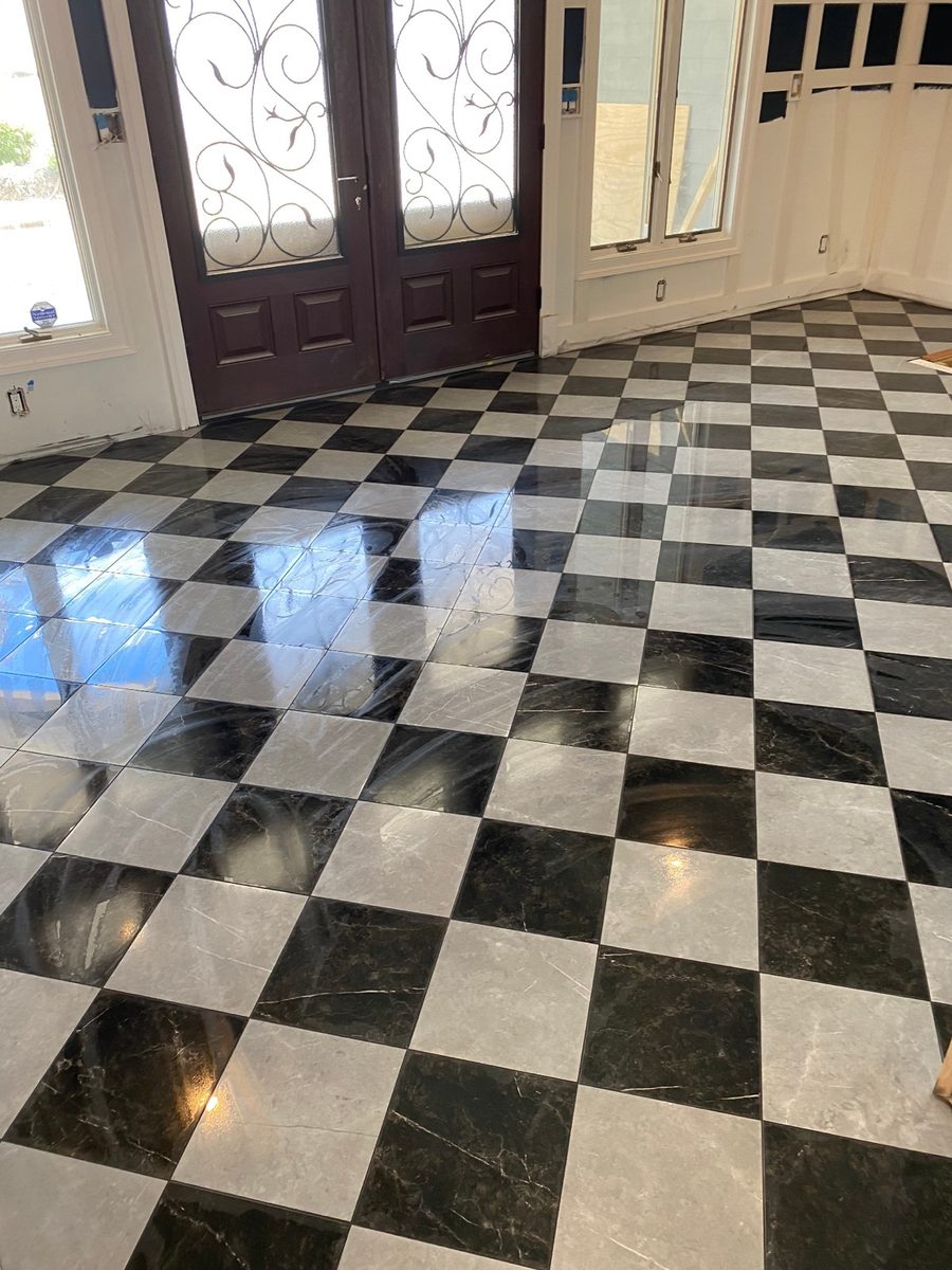 Finished black and white checkered floor tile