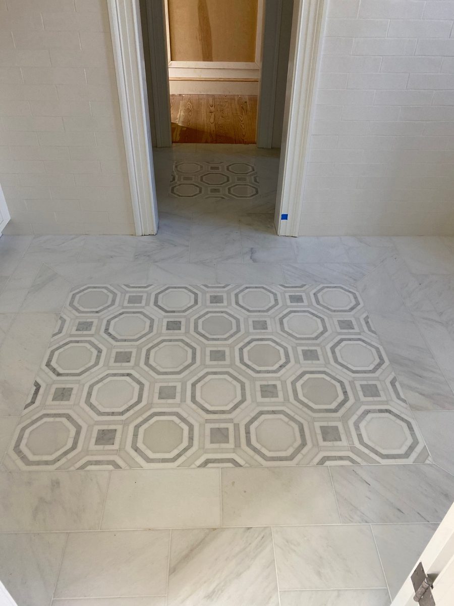 Finished marble floor with a decorative octagon tile inlay by MCode