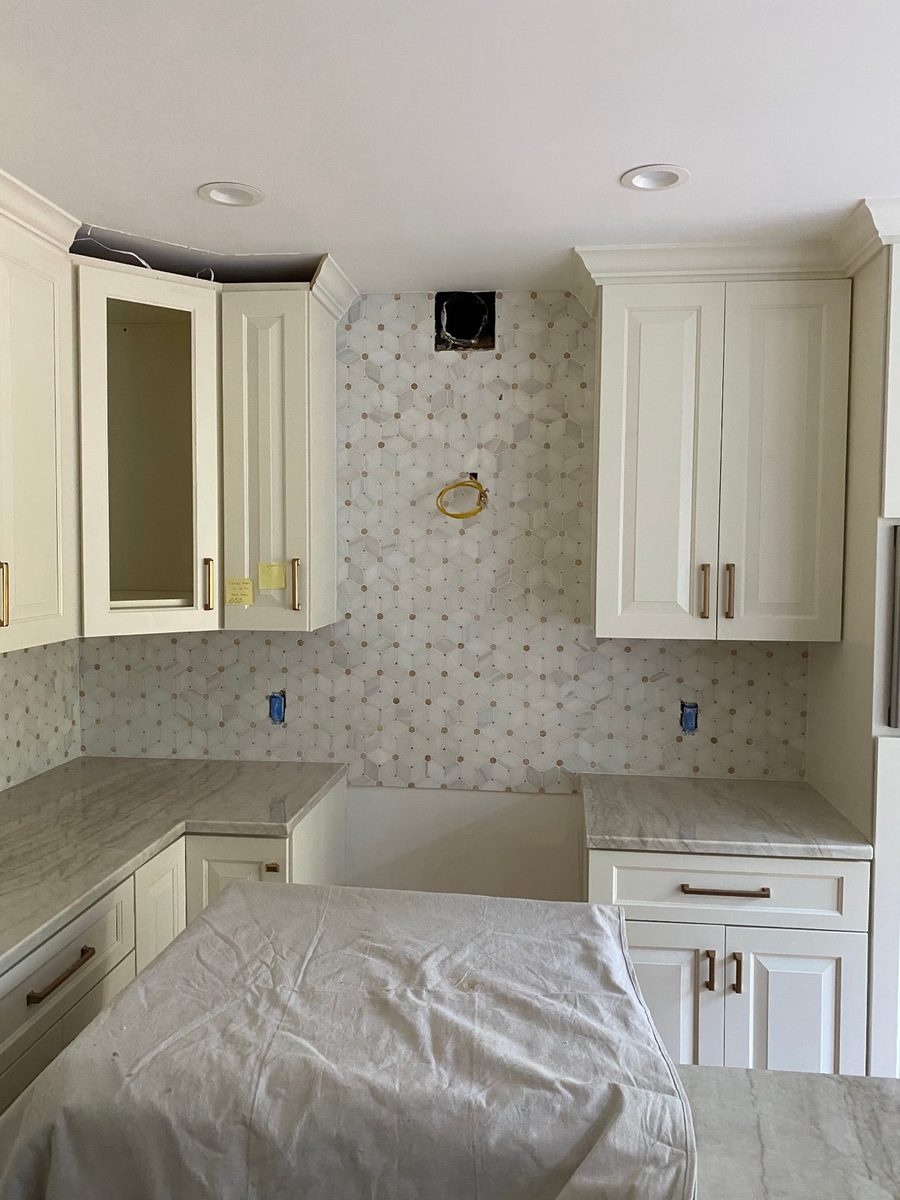 Natural stone marble hexagon mosaic backsplash on a kitchen wall