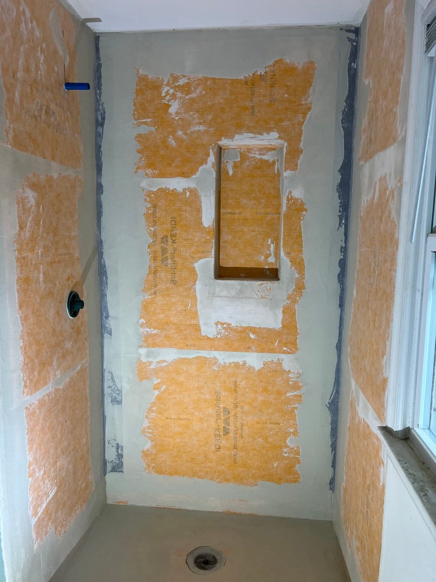 Waterproofing membrane on shower walls with the niche opening cut in