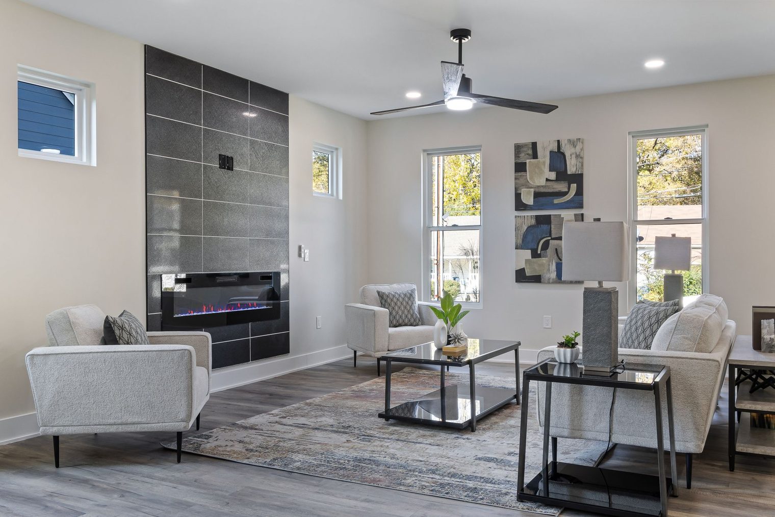 Modern living room with a dark large-format tiled fireplace surround running floor to ceiling