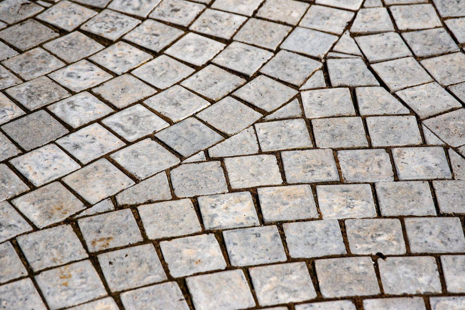 Natural tumbled stone floor tile with wide grout joints, the kind that needs sealing