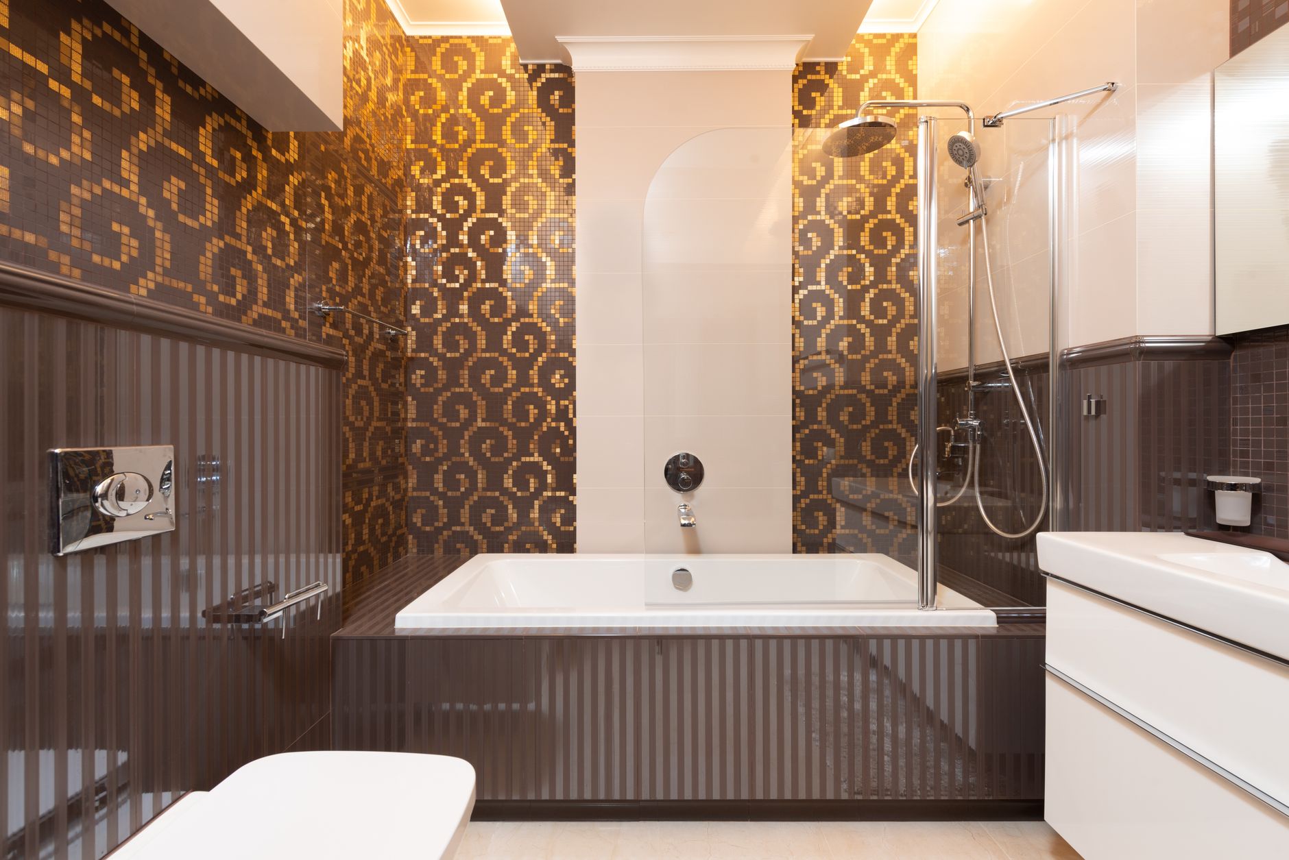 Glass mosaic tile feature wall in a bathroom, small glass tiles set in a swirl pattern