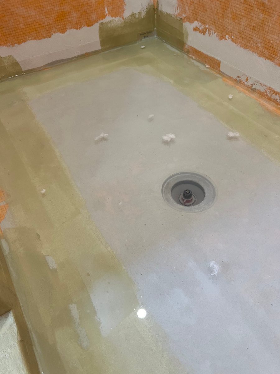 Shower pan flood test with the drain plugged and the base filled with water to check for leaks