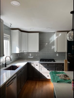 Kitchen with grey glass subway tile backsplash and quartz countertops
