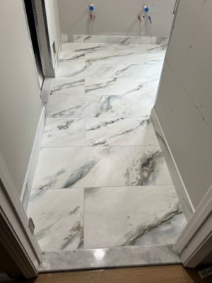 Marble-look bathroom floor tile installation