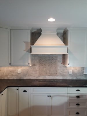 Elegant kitchen with mosaic tile backsplash feature