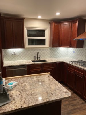 Arabesque tile kitchen backsplash with cherry cabinets