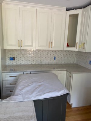 Elegant kitchen with marble hexagon backsplash